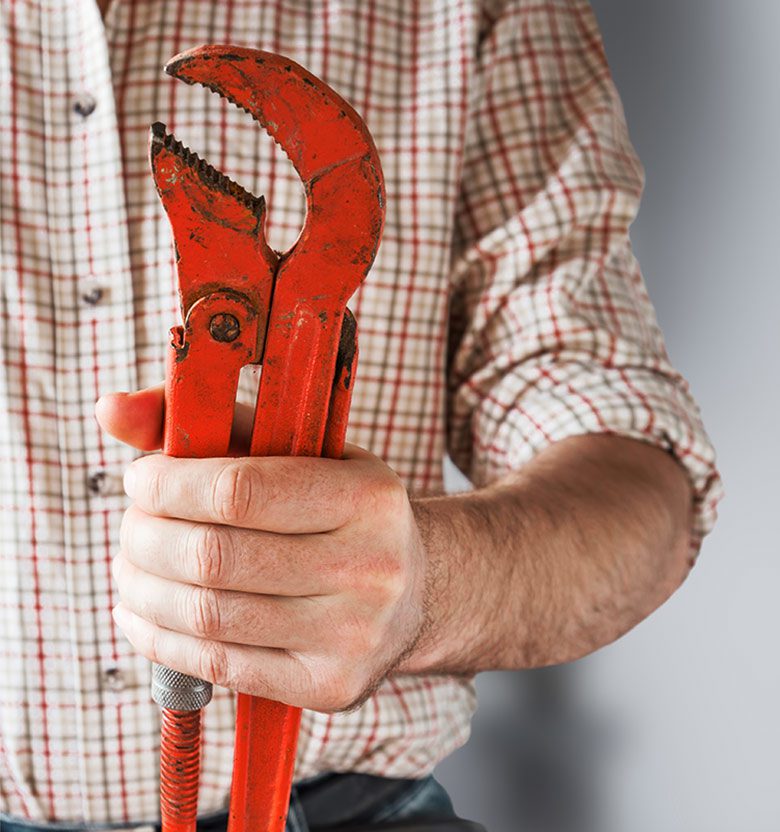 Man Holding Adjustable Wrench